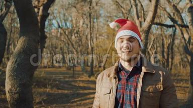 一个戴着圣诞帽的男人用一个超级、酷、<strong>优秀</strong>和微笑的标志<strong>展示</strong>他的手。
